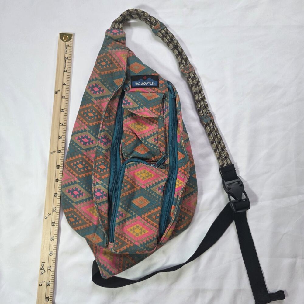 KAVU Aztec Print Rope Sling Bag featuring a teal canvas body with a vibrant neon
